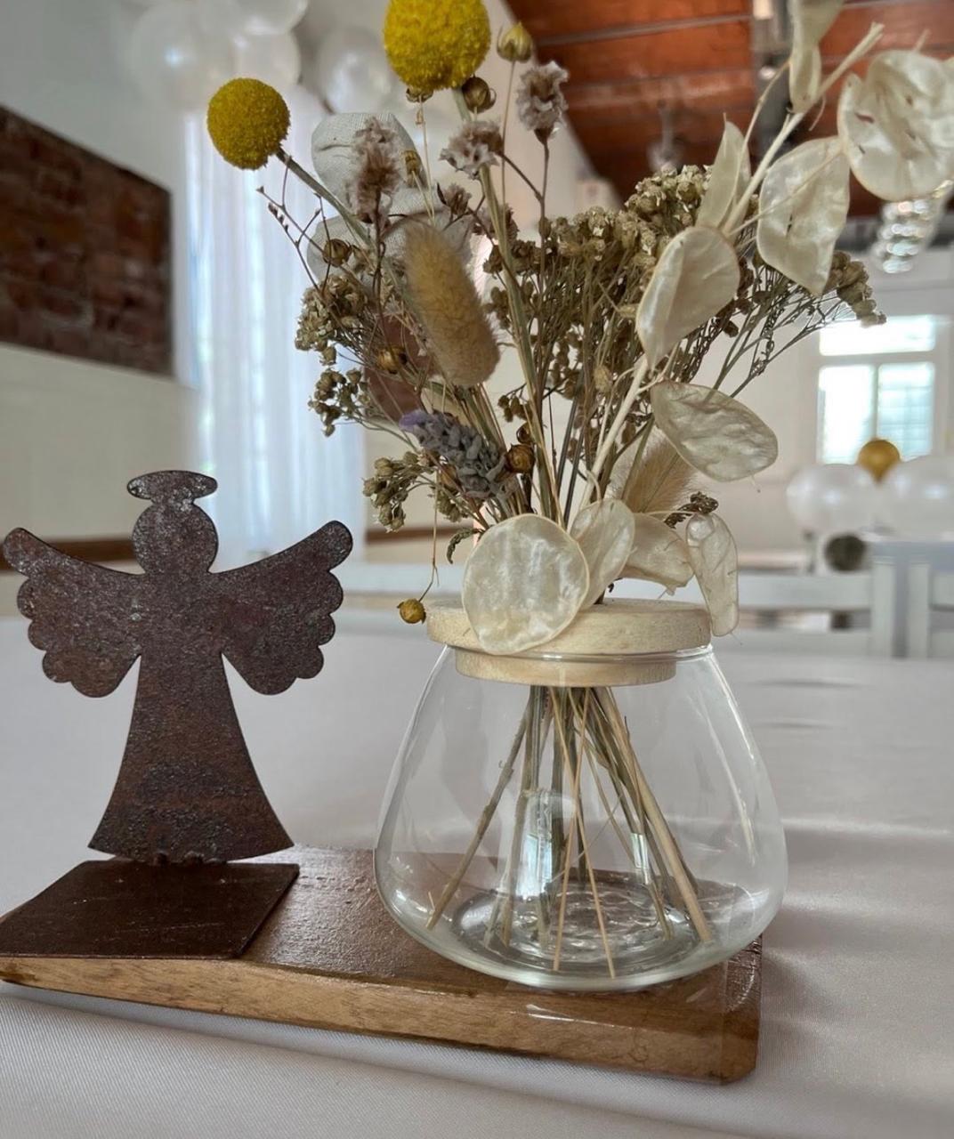Centro de mesa con flores secas y figura de ángel